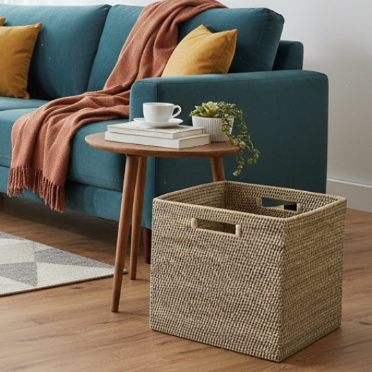 Living room with teal sofa, wooden side table, and woven basket.