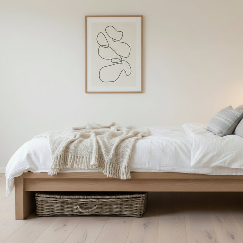Bedroom with a bed, basket, and abstract art on the wall.