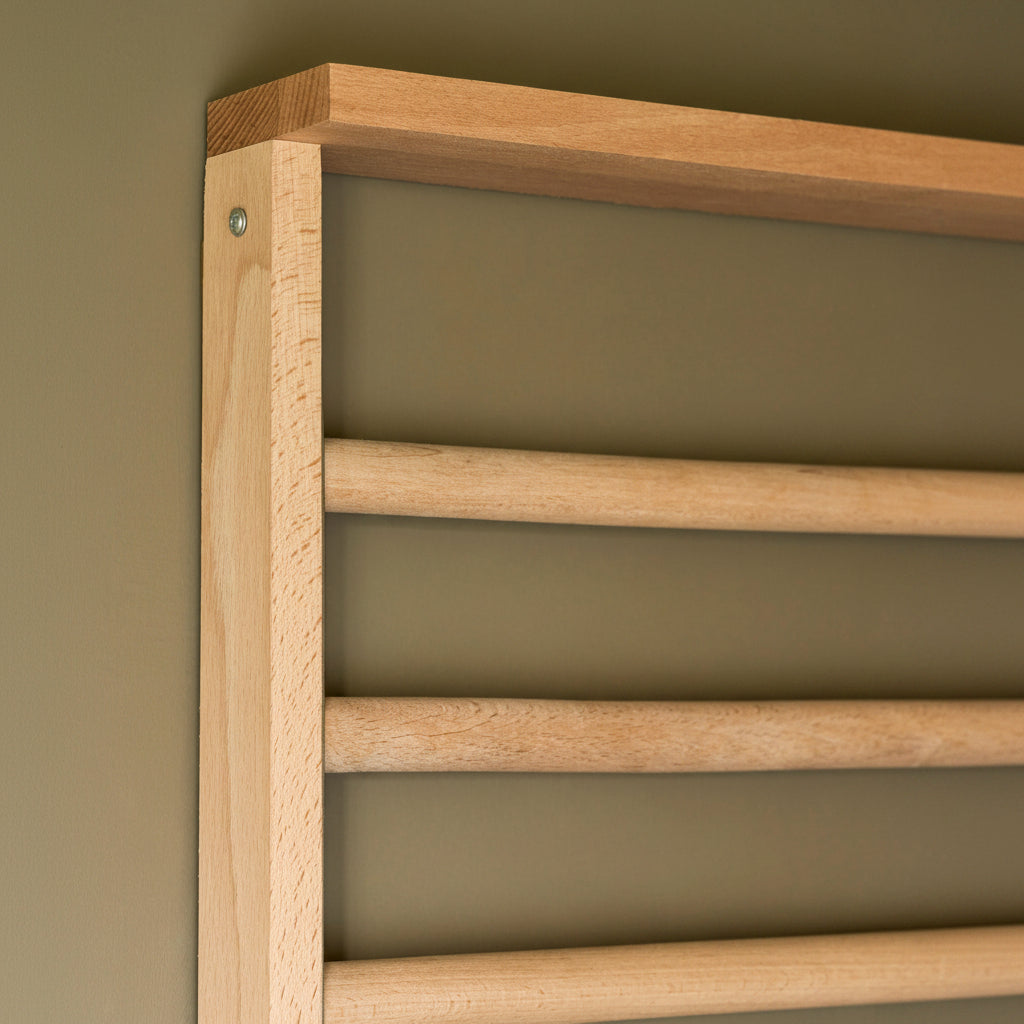 Wooden radiator against a green wall