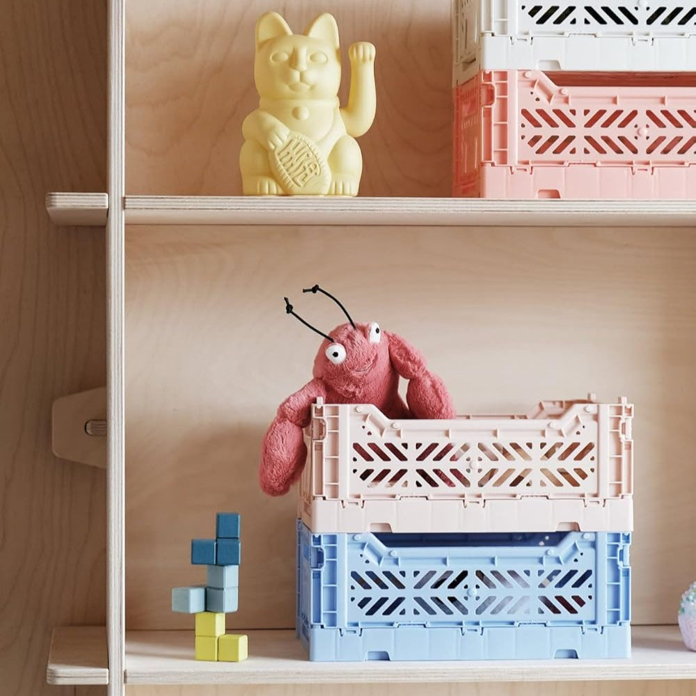 Wooden shelves with colorful crates and toys against a wooden wall.