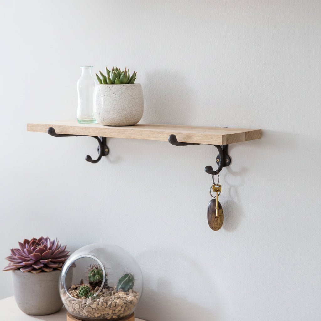 Wooden shelf with plants and a terrarium on a white surface.