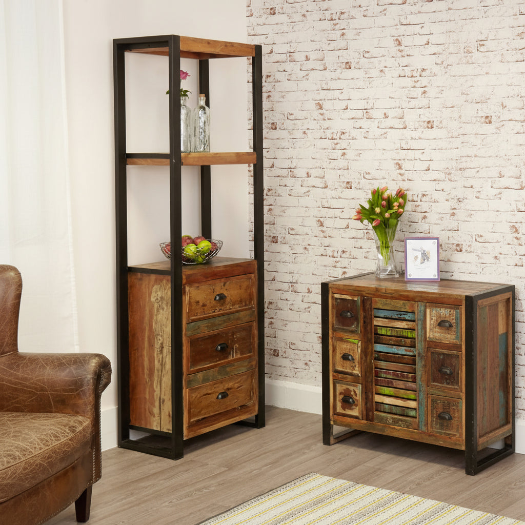 Wooden bookshelf and side table against a brick wall.