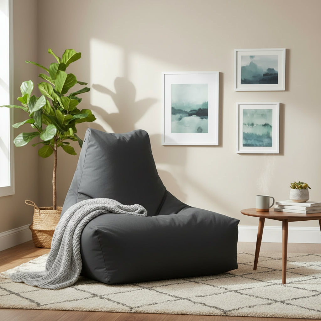 Gray bean bag chair on a wooden deck with plants in the background