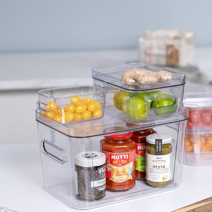 Clear plastic storage containers with food items on a kitchen counter