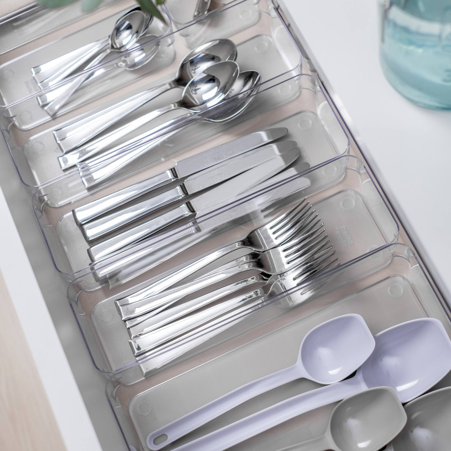 Silverware set in a clear organizer with a white background
