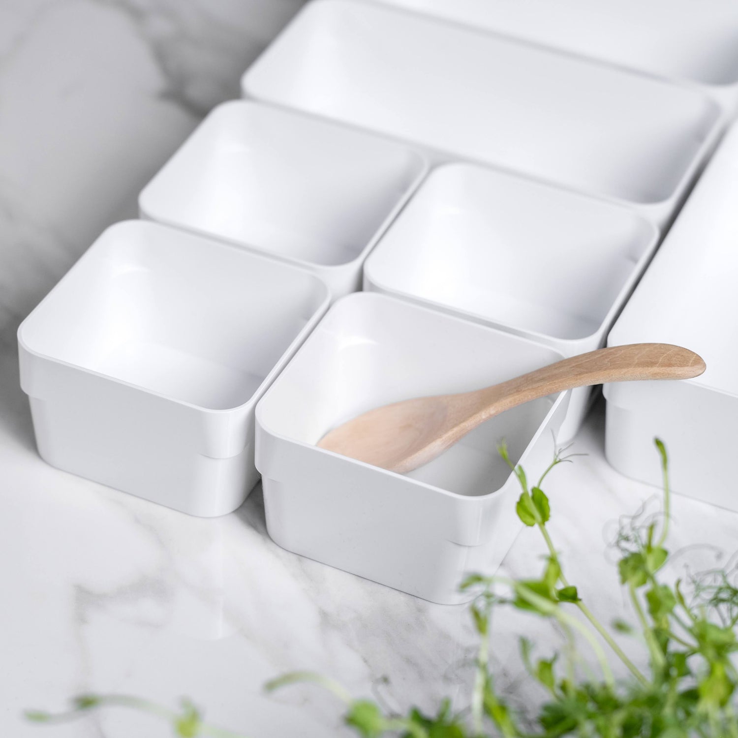 White ceramic tray with compartments on a marble surface