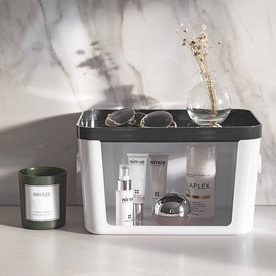 Cosmetic products on a white surface with a marble wall in the background