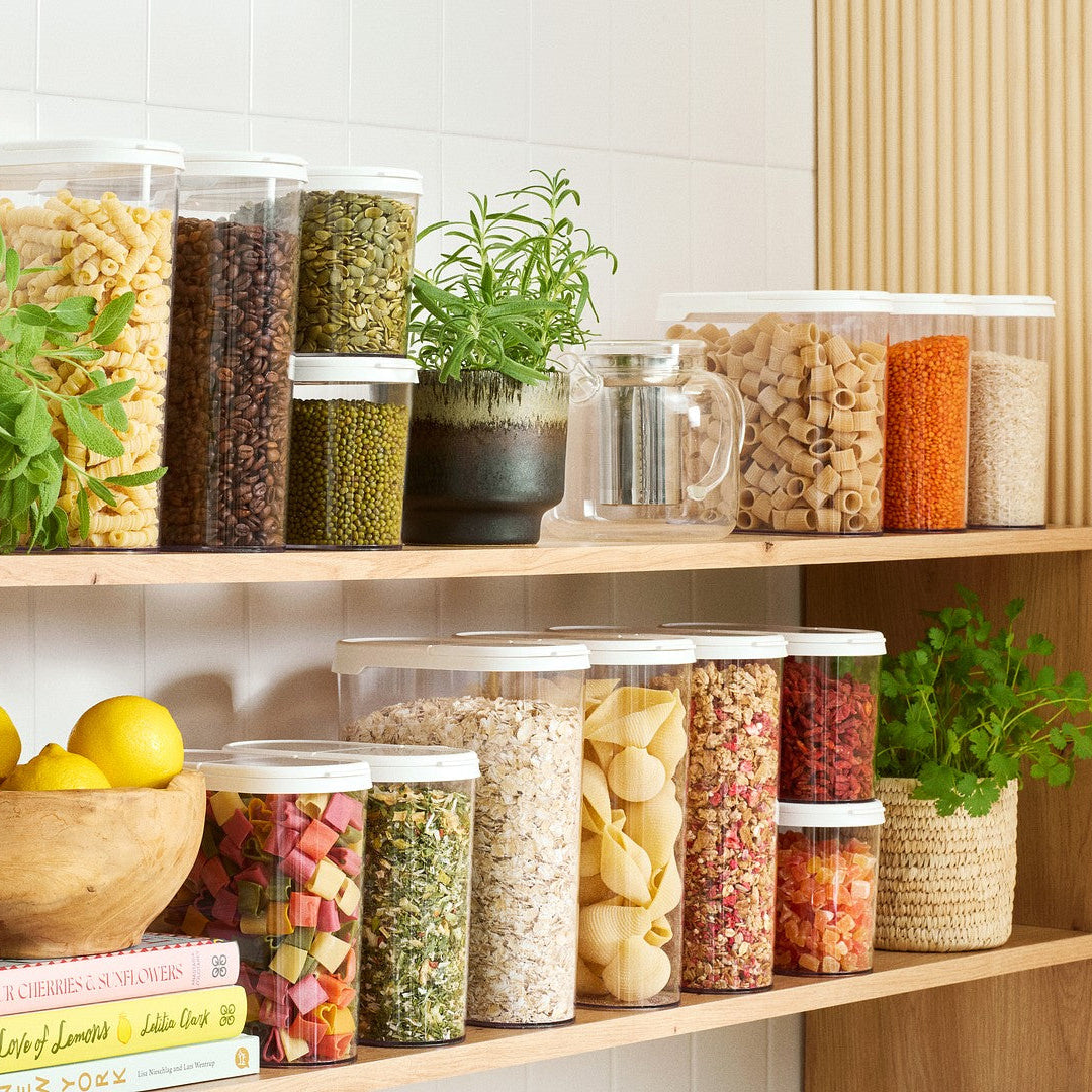 Shelves with various food items and containers in a kitchen setting