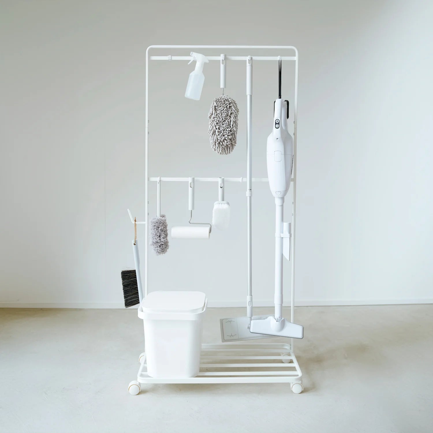 White cleaning tool organizer with various brushes and sponges on a white background