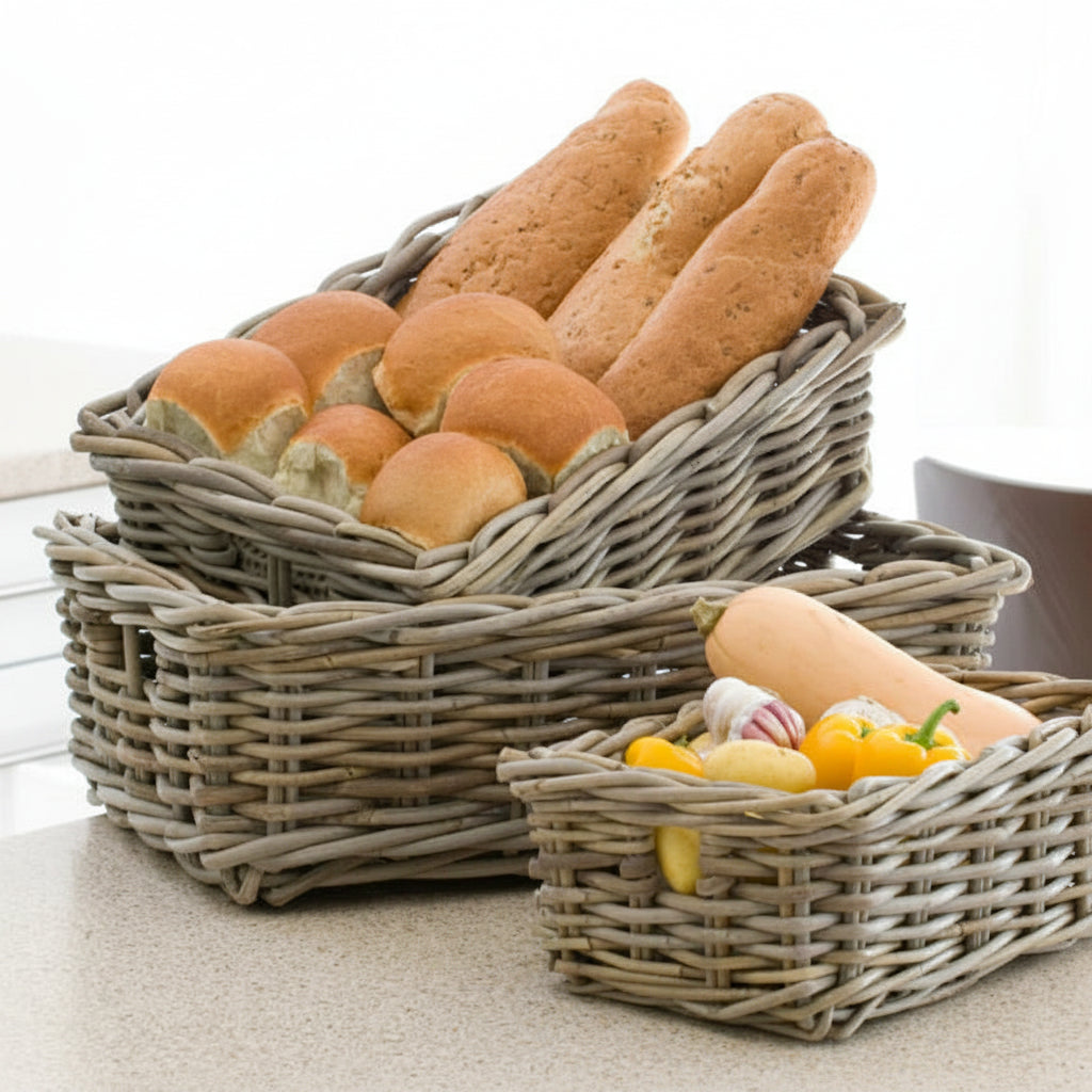Wicker baskets with bread and pastries on a light background