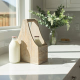 Wooden toolbox on a kitchen counter with a bottle of milk and a vase of flowers.