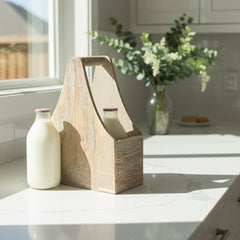 Wooden toolbox on a kitchen counter with a bottle of milk and a vase of flowers.