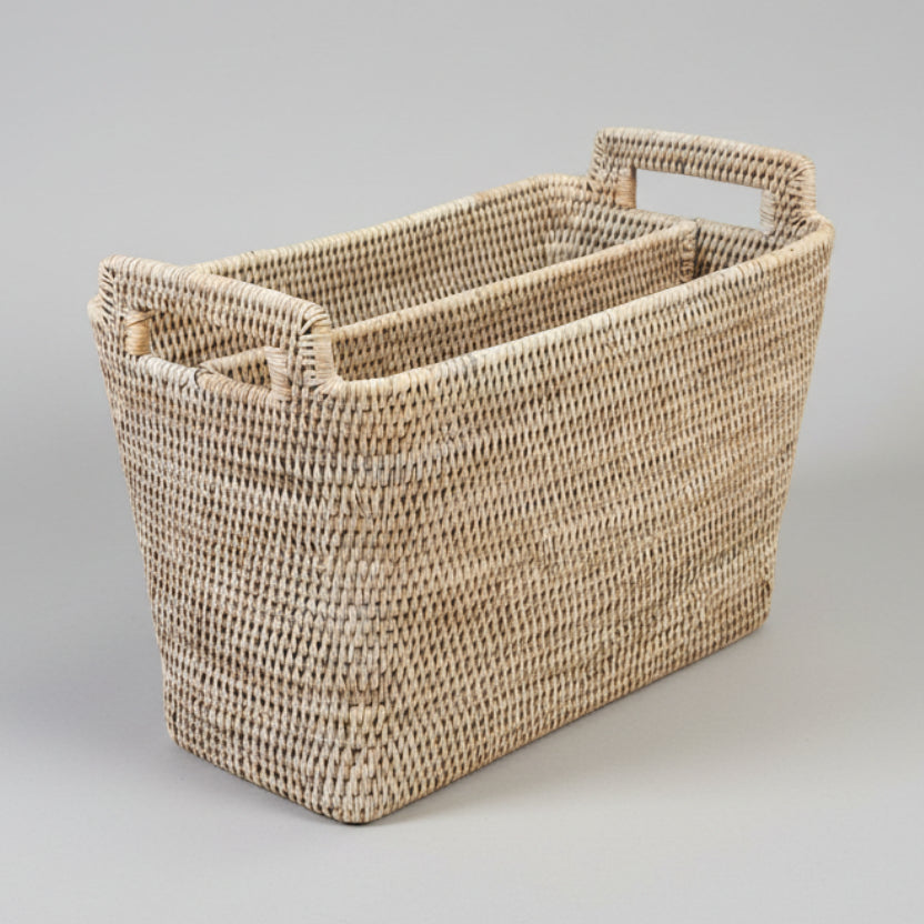 Woven basket with handles on a gray background