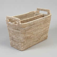 Woven basket with handles on a gray background