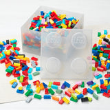 Colorful LEGO bricks with clear storage containers on a white background