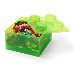 Green toy box with colorful building blocks on a white background