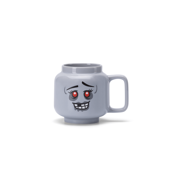 Gray mug with a cartoon face design on a white background