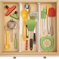 Wooden kitchen drawer with colorful utensils and tools