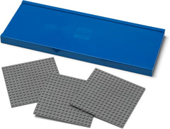 Two gray building blocks and a blue storage box on a white background