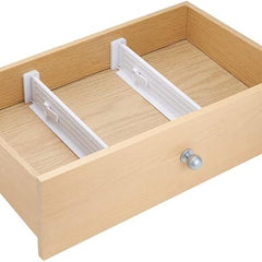 Wooden drawer with white dividers on a white background