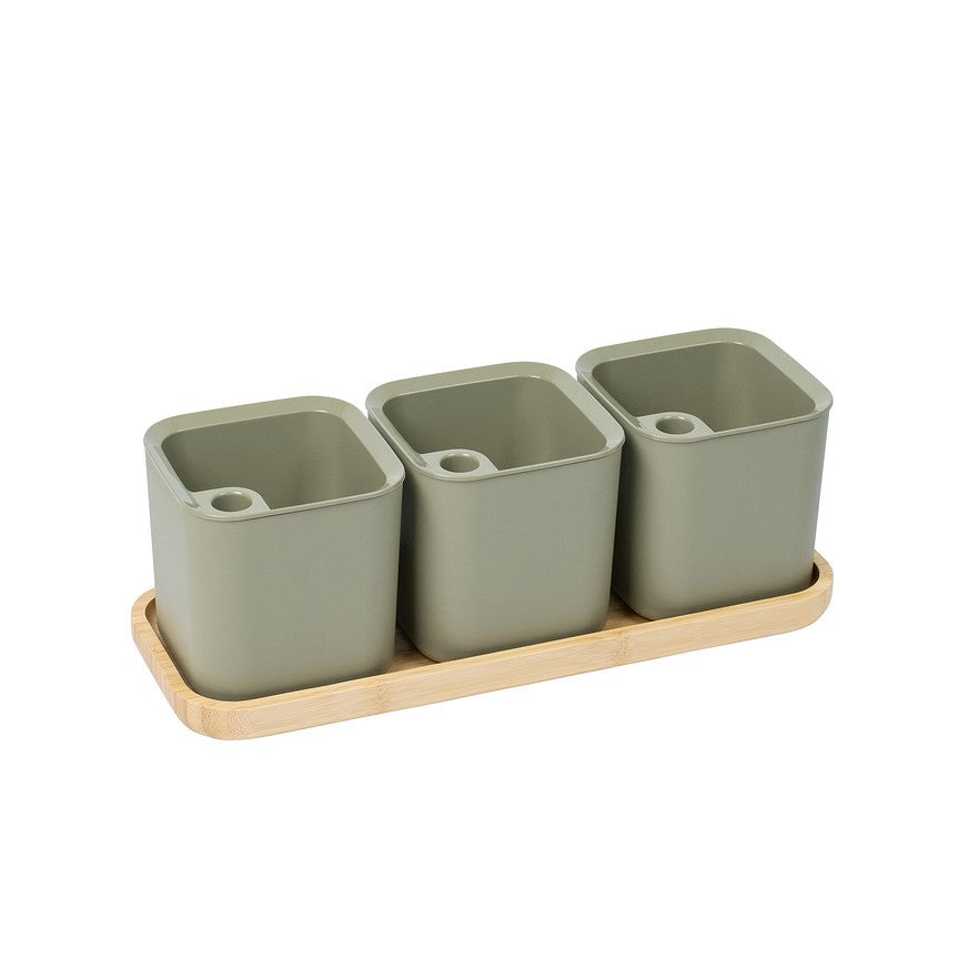 Set of three green square pots on a wooden tray with a white background