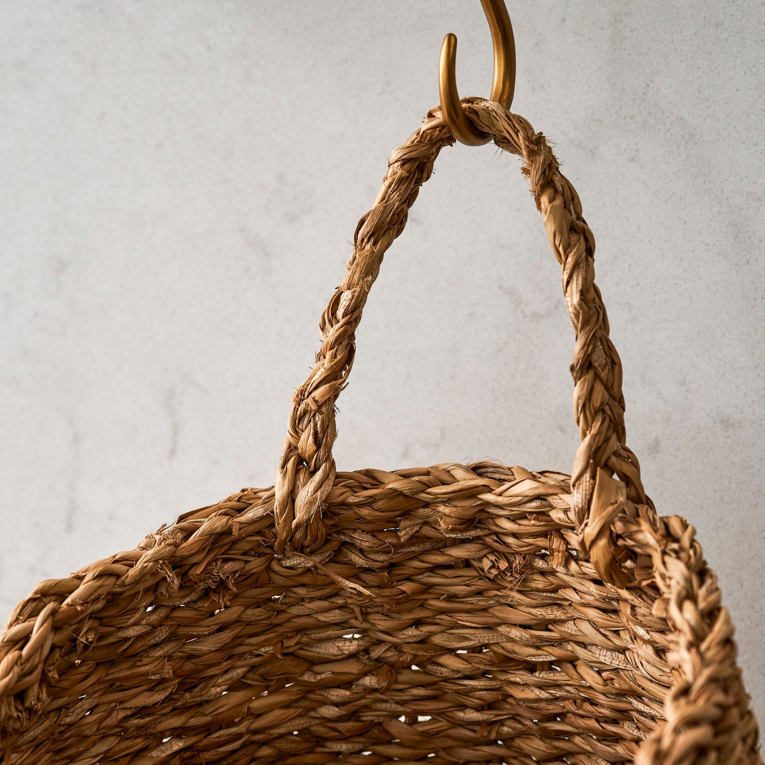 Woven basket with a handle on a neutral background