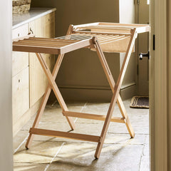 Wooden folding table in a room with a neutral color scheme