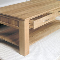 Wooden coffee table with a drawer on a white carpet