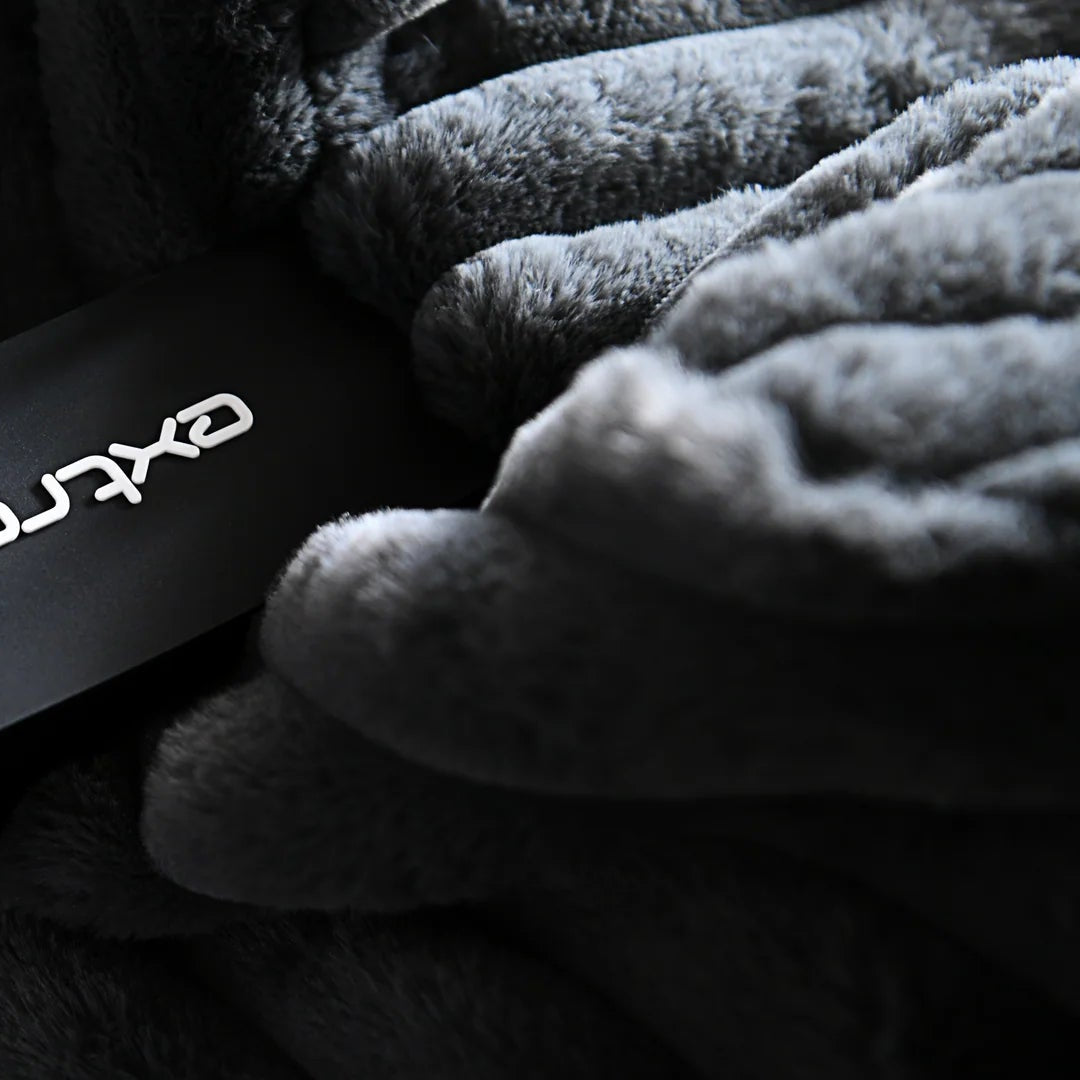 Close-up of a person wearing gloves holding a black band with 'Oxyrama London' branding.