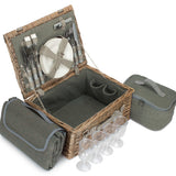 Picnic basket set with cutlery, plates, and wine glasses on a white background