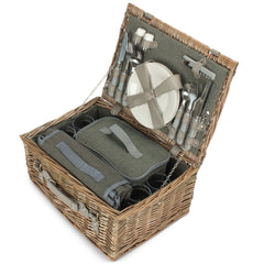 Open picnic basket with cutlery and tableware on a white background