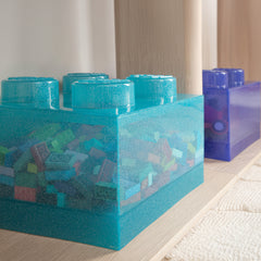 Blue toy blocks on a light wooden surface with a blurred background