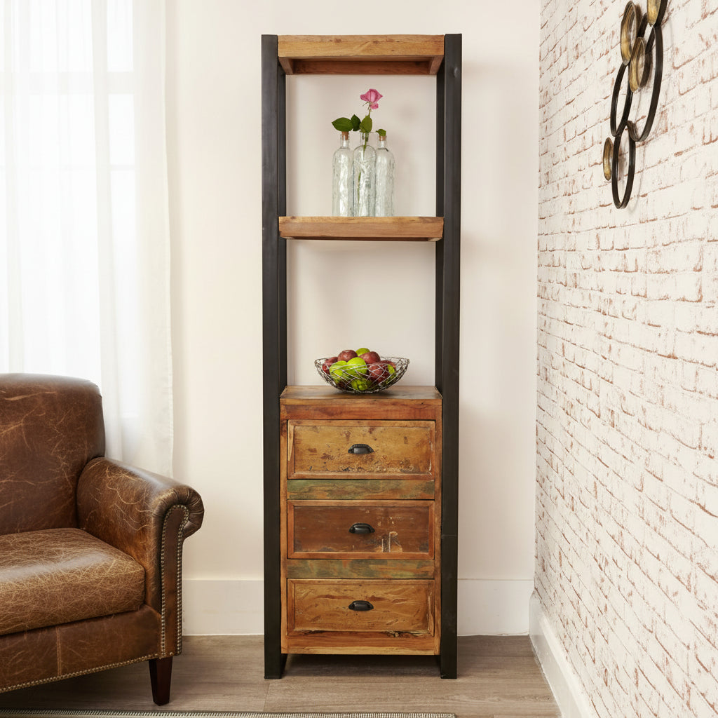 Tall wooden shelf with three drawers against a white brick wall.