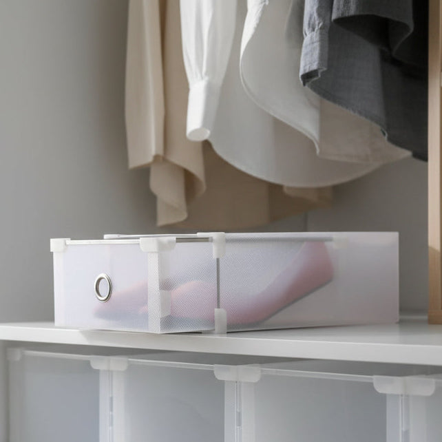 Clear plastic storage box with a white handle on a white background