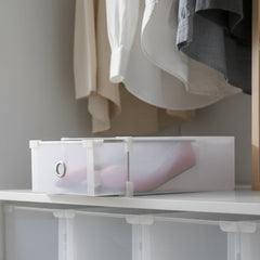 Clear plastic storage box with a white handle on a white background