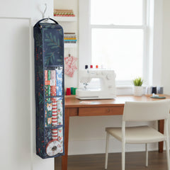 Tall, dark green bag with floral patterns on a white background