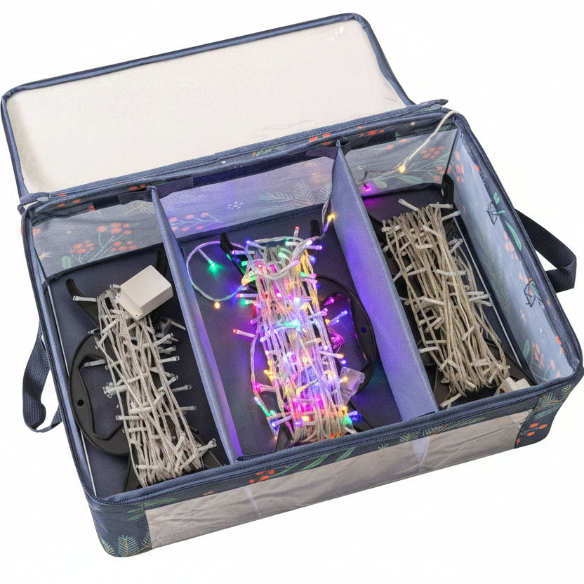 Set of Christmas lights and decorations in a clear storage box on a white background