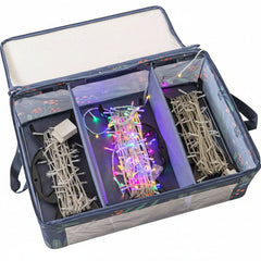 Set of Christmas lights and decorations in a clear storage box on a white background