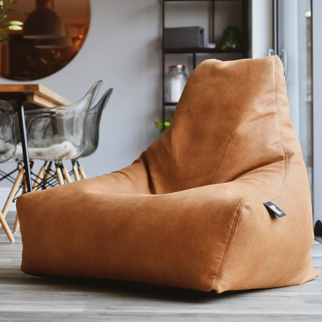 Brown bean bag chair in a modern living room with a dining table and chairs.