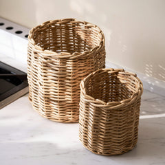 Two woven baskets on a light surface