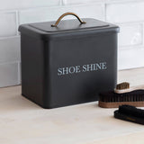 Black shoe shine box with 'SHOE SHINE' text on a white tiled floor.