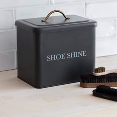 Black shoe shine box with 'SHOE SHINE' text on a white tiled floor.