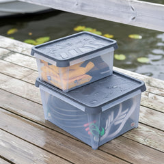 Two gray storage boxes stacked on a wooden deck by a body of water.