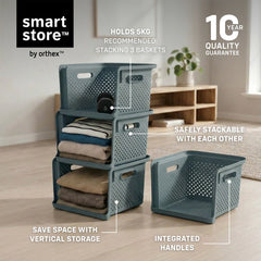 A set of dark teal plastic storage baskets shown in a styled room setting, with some folded towels and blankets inside. The image includes text callouts highlighting features like 'Holds 5kg', 'Safe stackable with each other', 'Integrated handles', and 'Save space with vertical storage'.