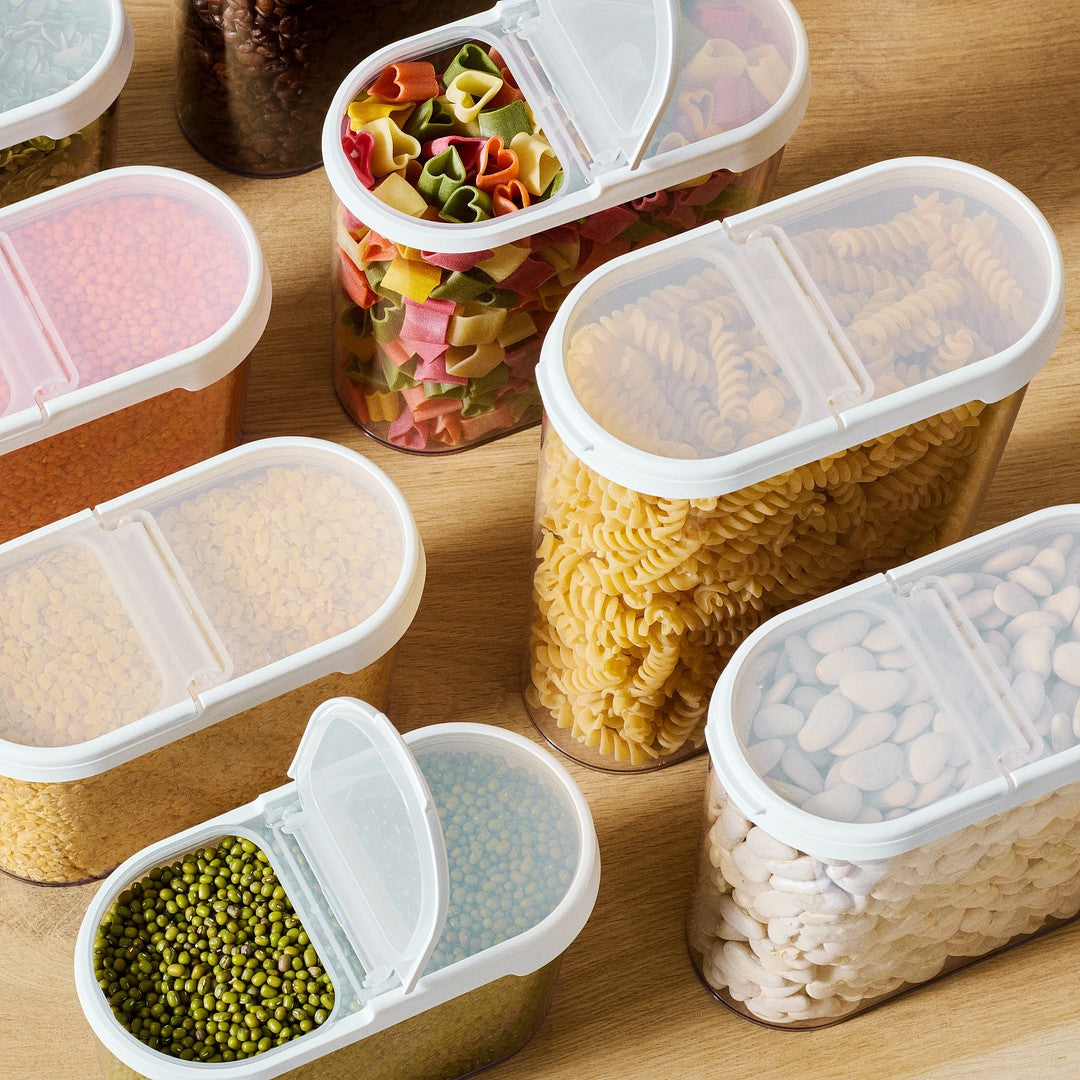Set of plastic food storage containers with different food items on a wooden surface