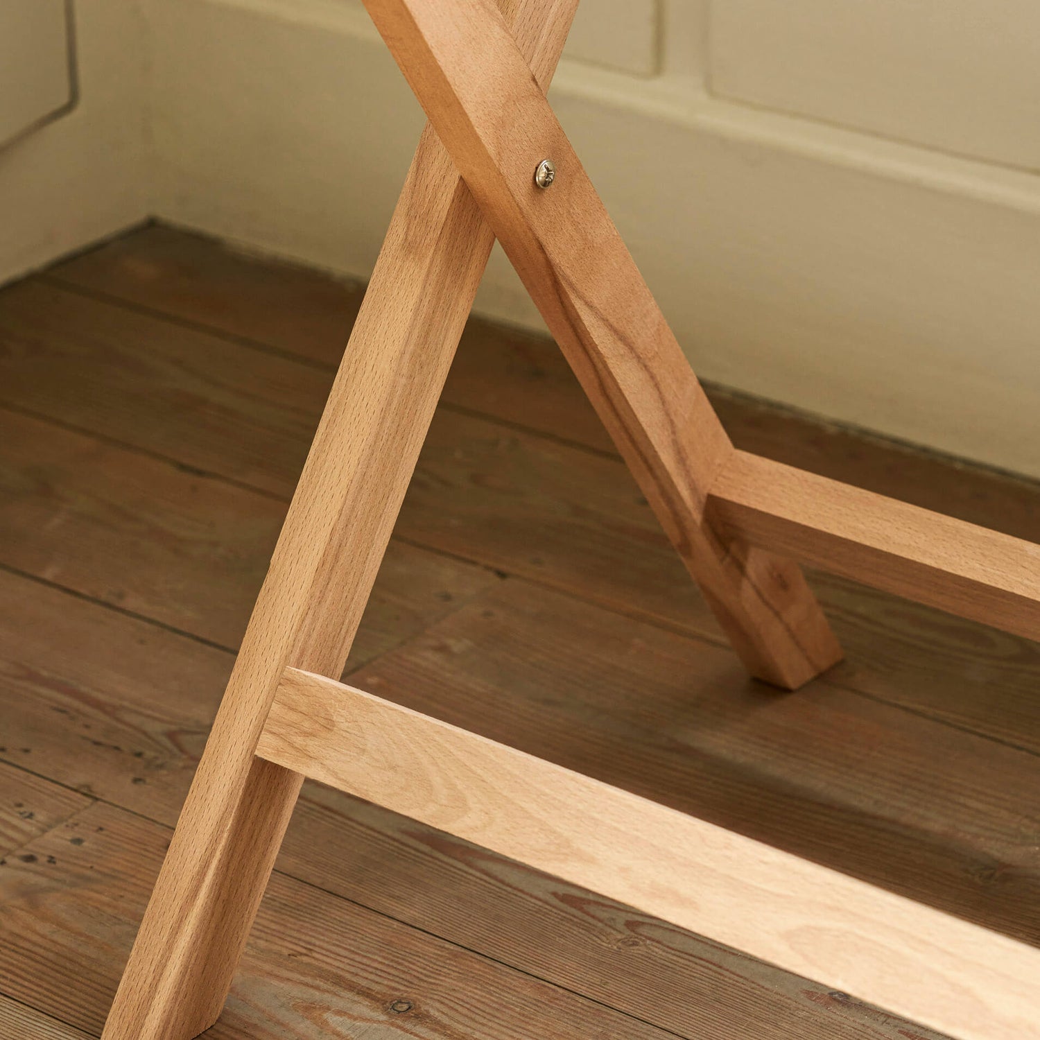 Wooden crossbar on a wooden floor with a neutral wall background