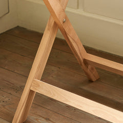 Wooden crossbar on a wooden floor with a neutral wall background