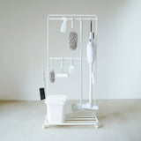 White cleaning tool organizer with various brushes and sponges on a white background