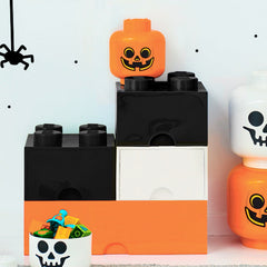 LEGO piece with a pumpkin face design on a white background
