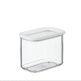 Clear storage container with a white lid on a white background